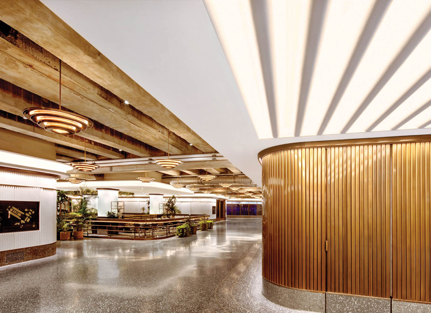 restaurant under wooden beam ceilings and separated from concourse by bronze railing