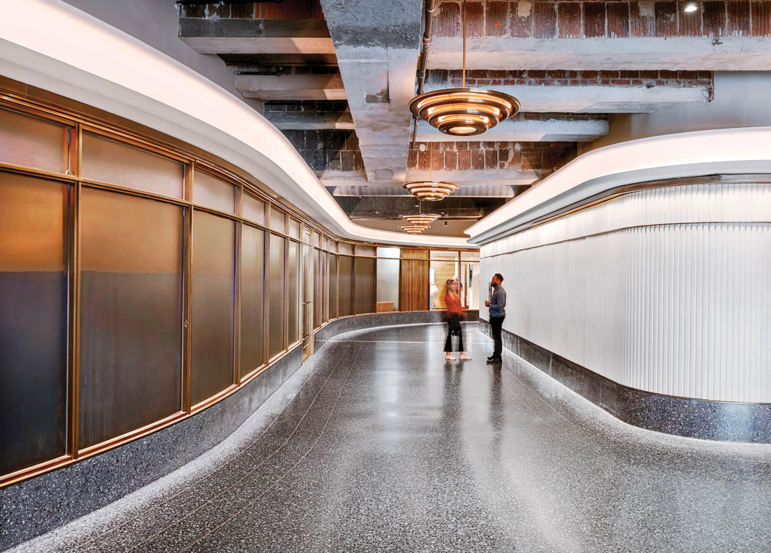 hallway with terrazzo flooring and brightly lit LED strip lights