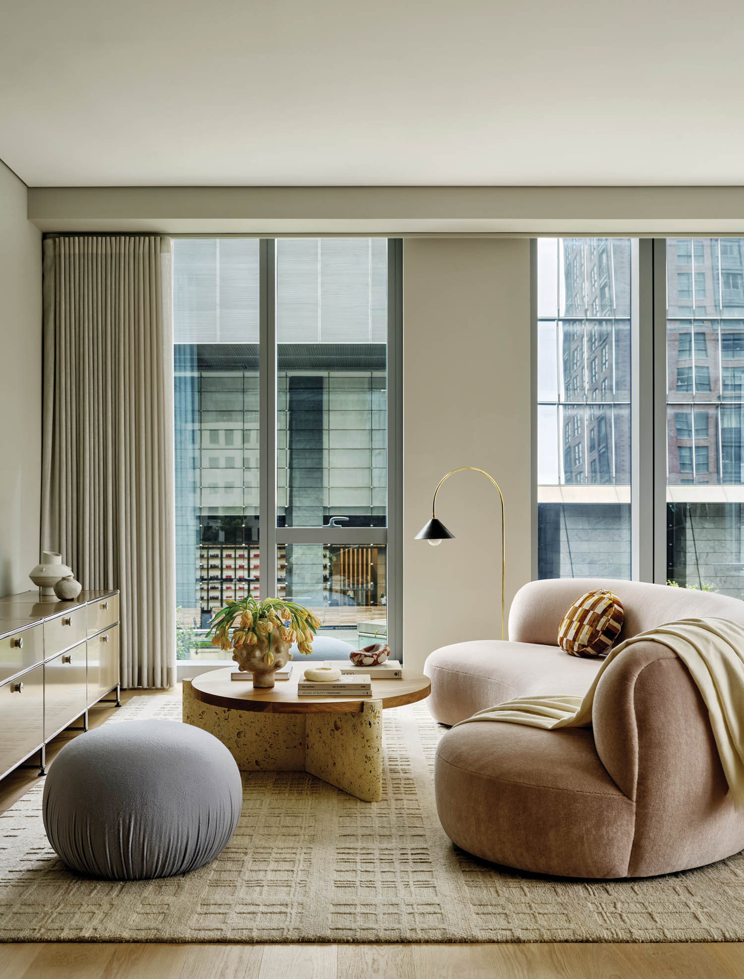 neutral living area with surrounding seating area and city view