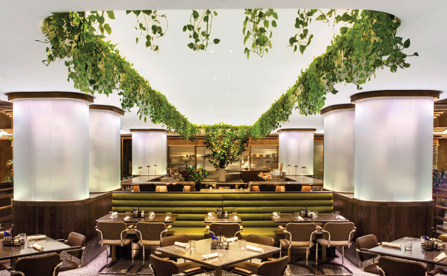 main dining area with lots of tables and greenery on top