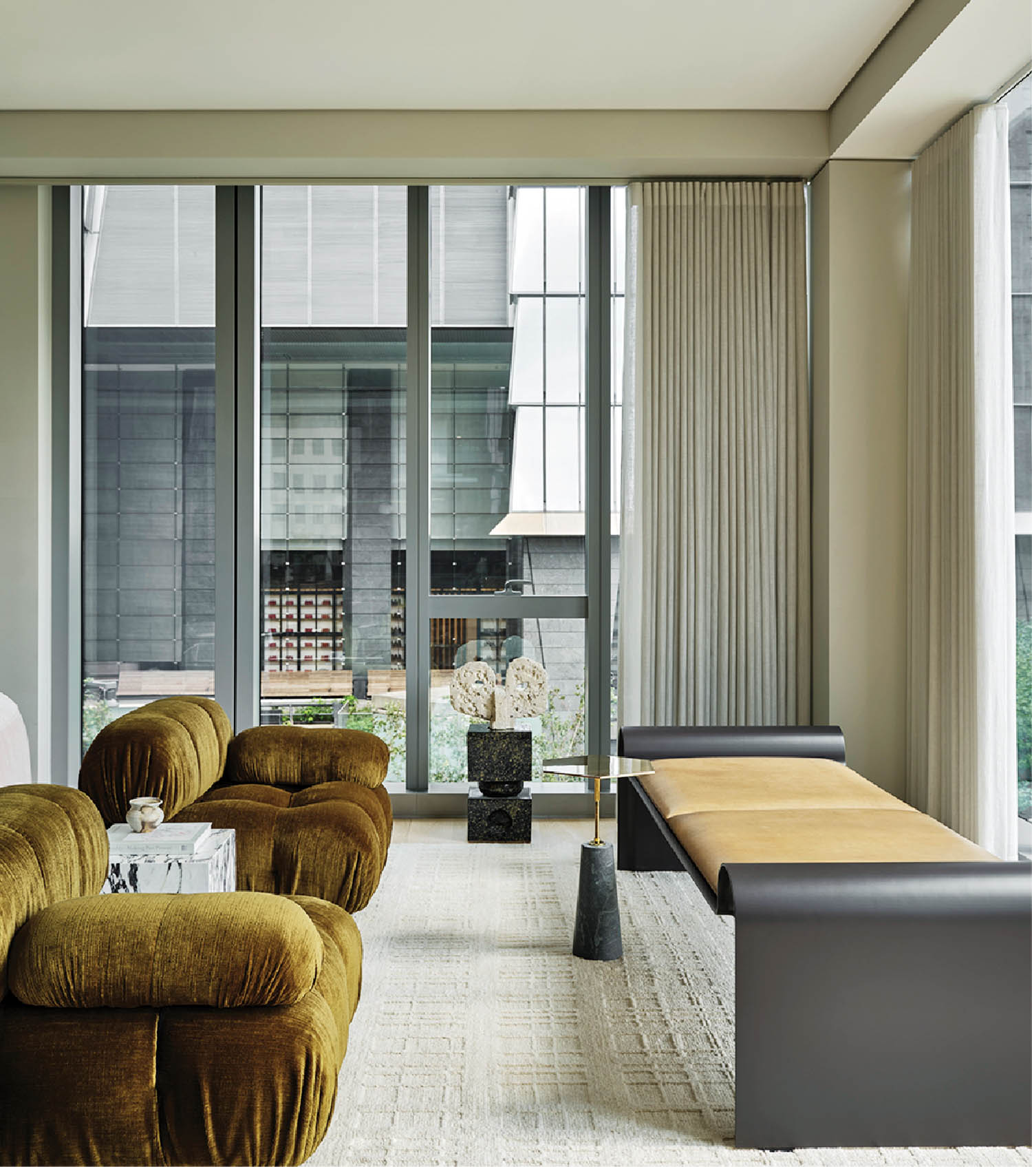 seating vignette in the living area with olive green sofas and desk