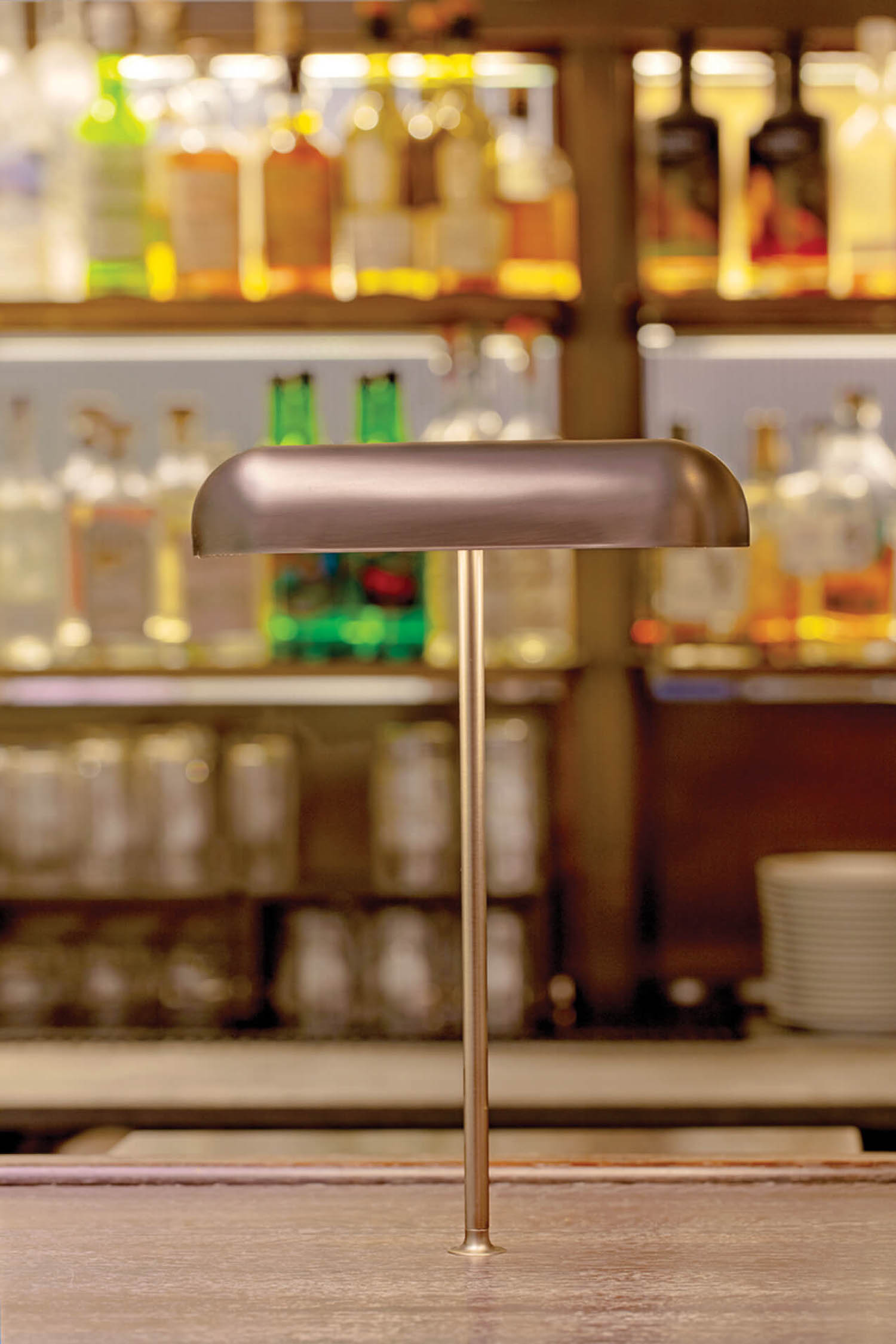 brown book lamp on top of an oak bar