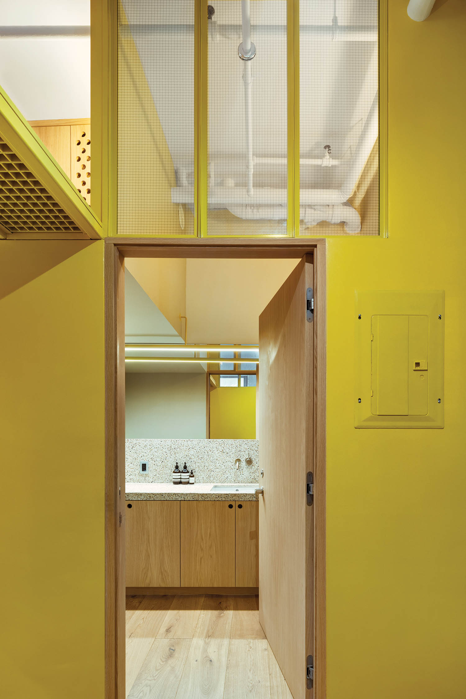 all yellow walls and doors leading to the bathroom