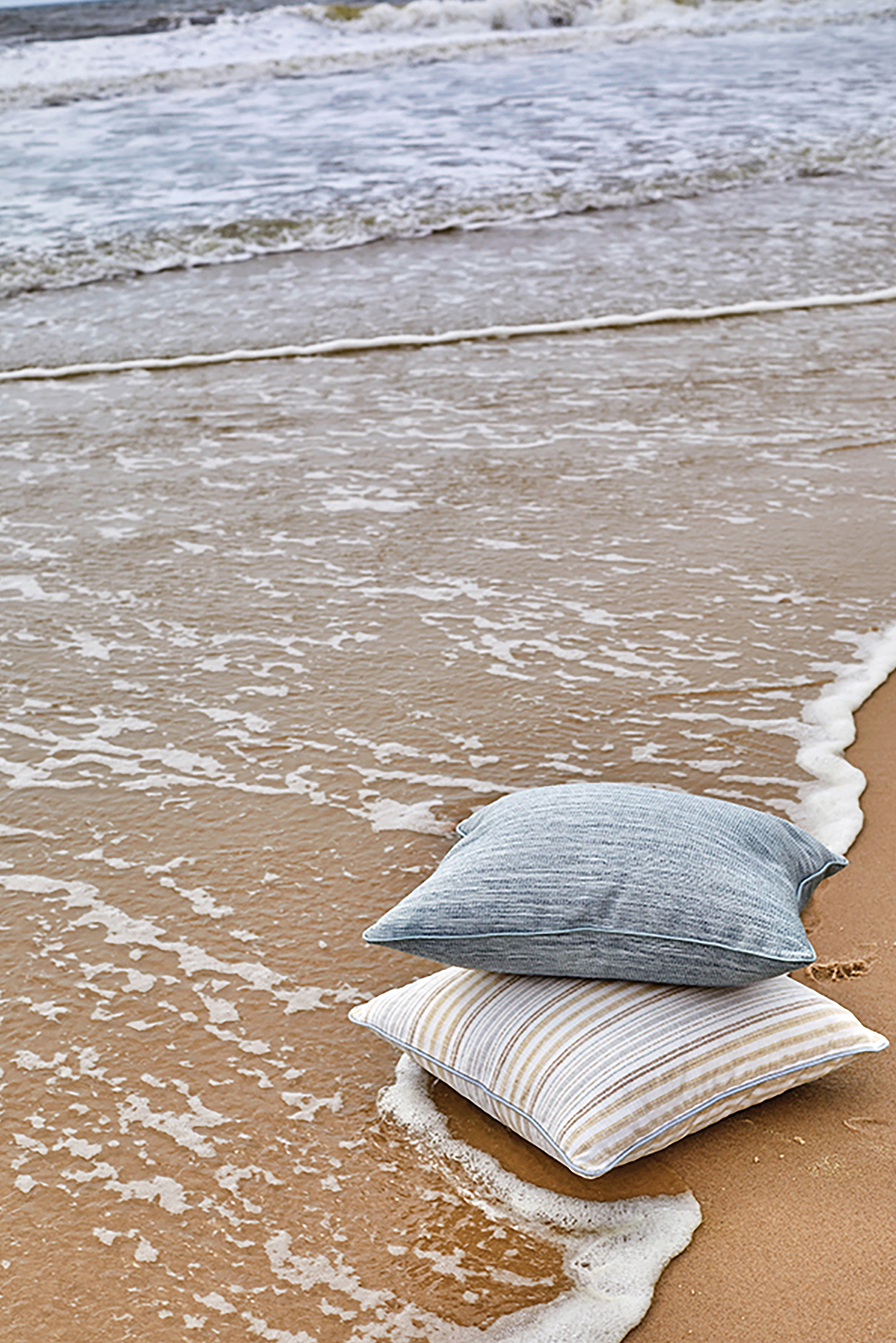 a pair of pillows on the beach