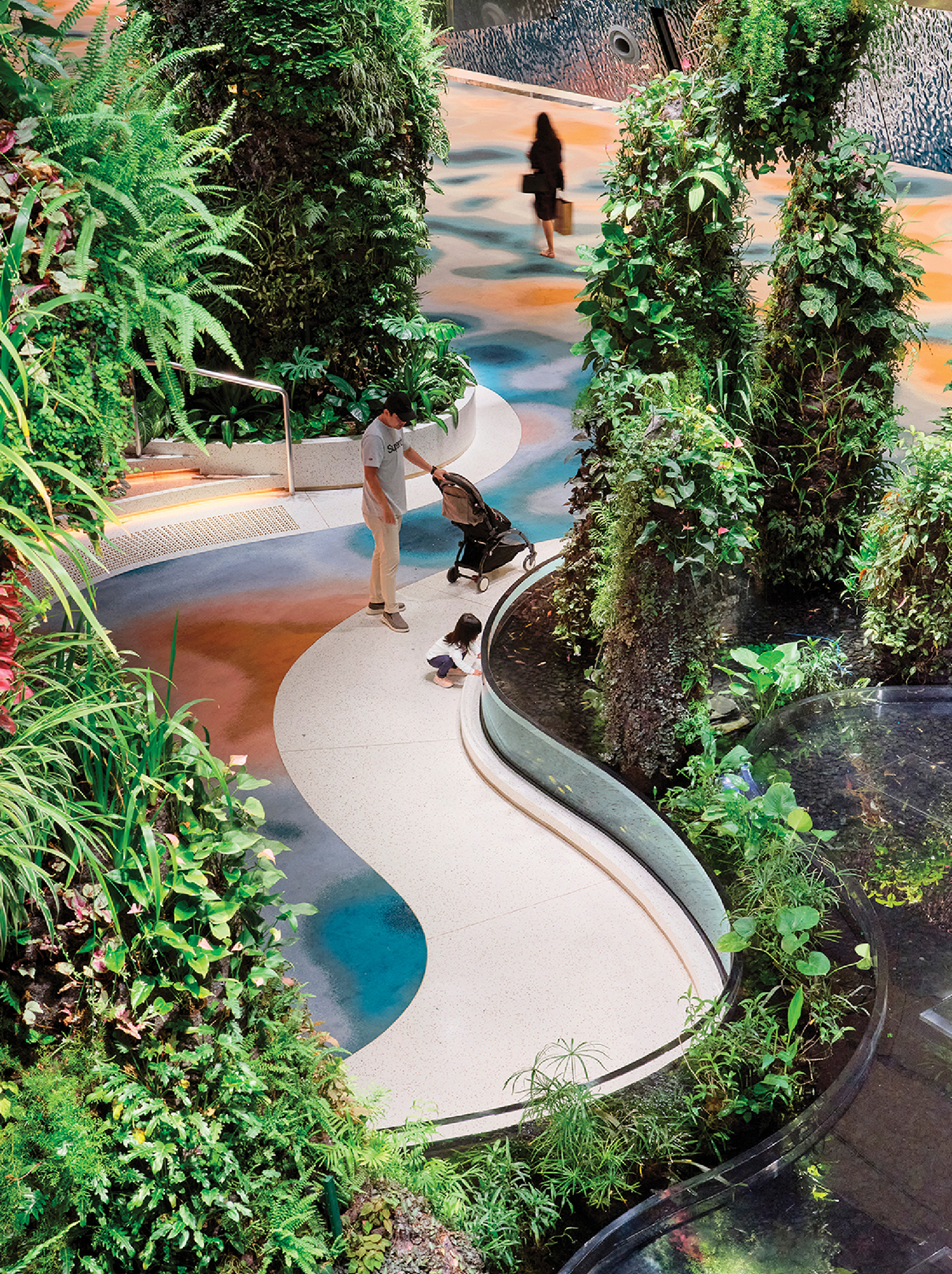 A woman is walking through a garden