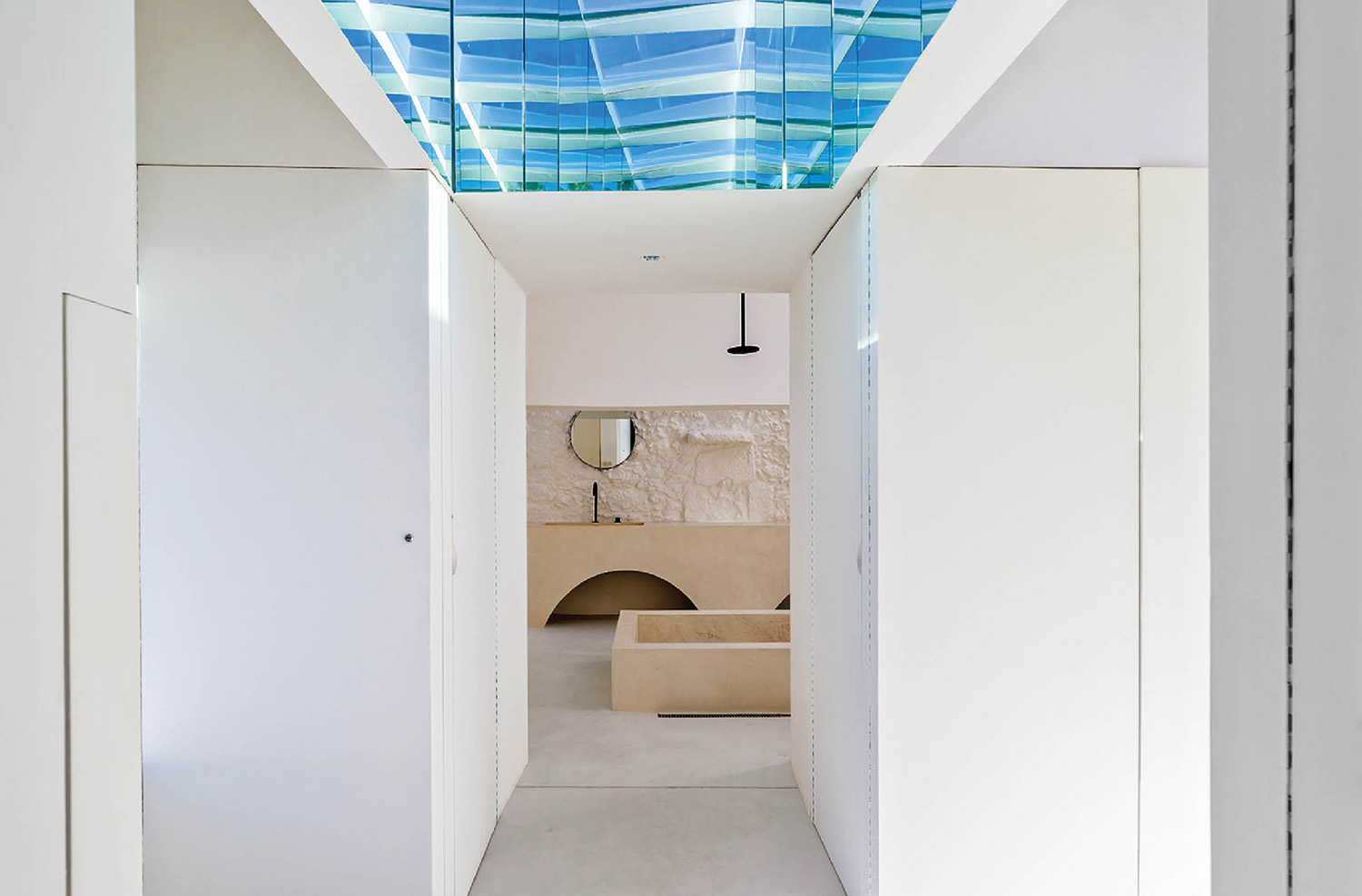 a bathroom with a blue ceiling and white walls