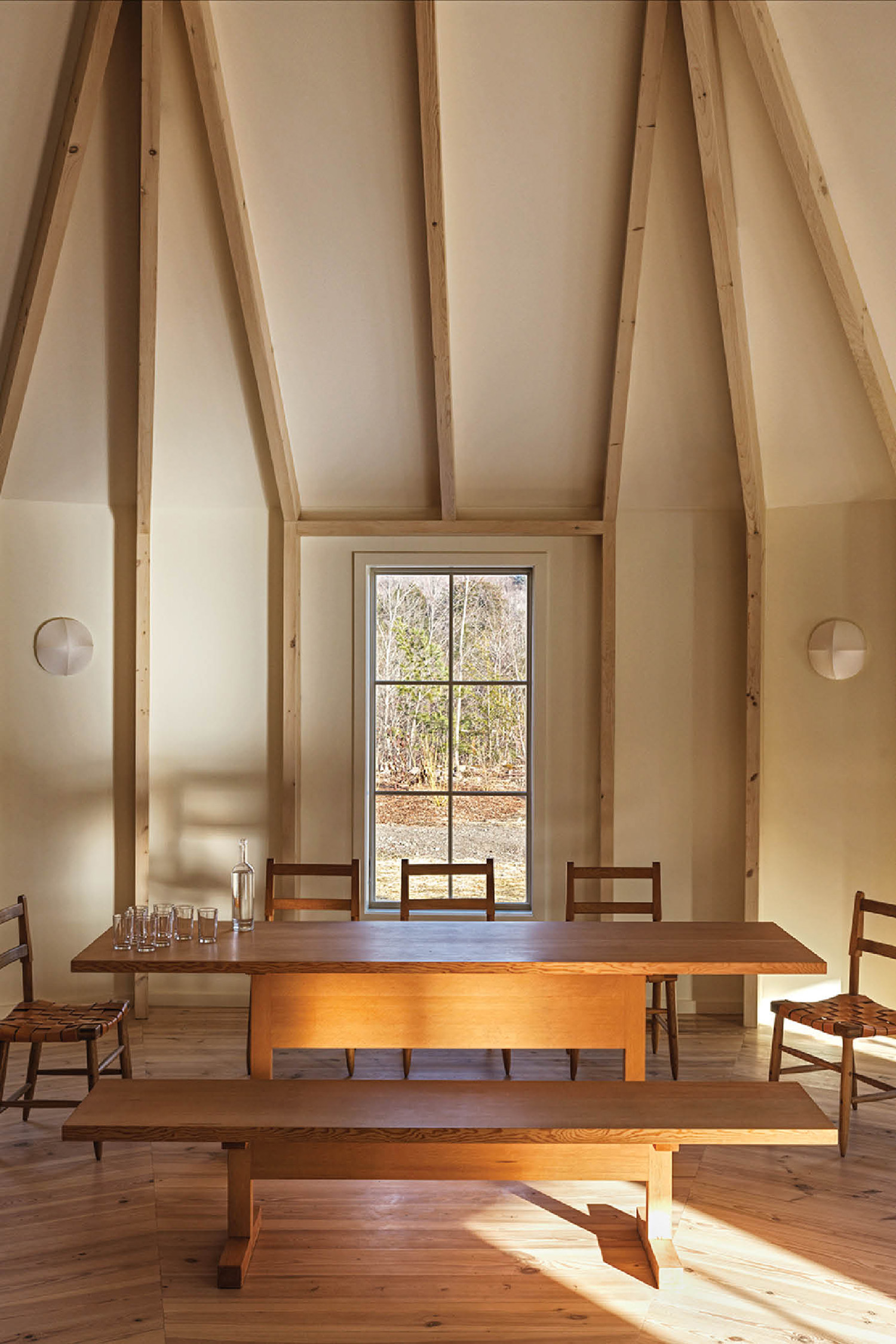 A room with a table and chairs and a window