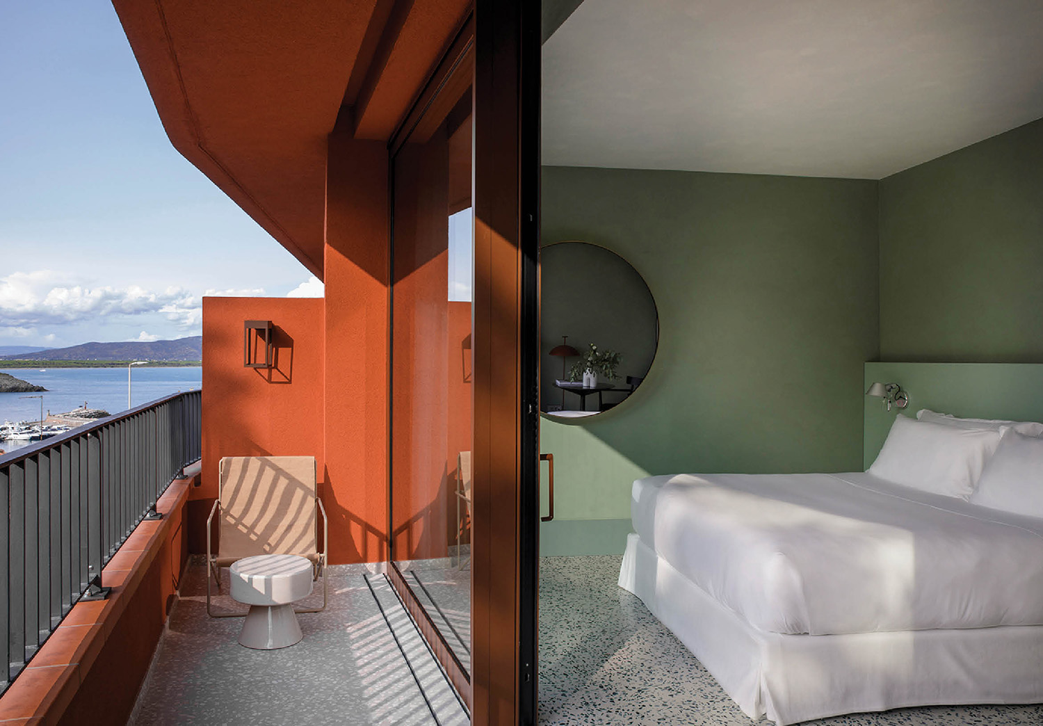 A bedroom with a balcony overlooking the ocean