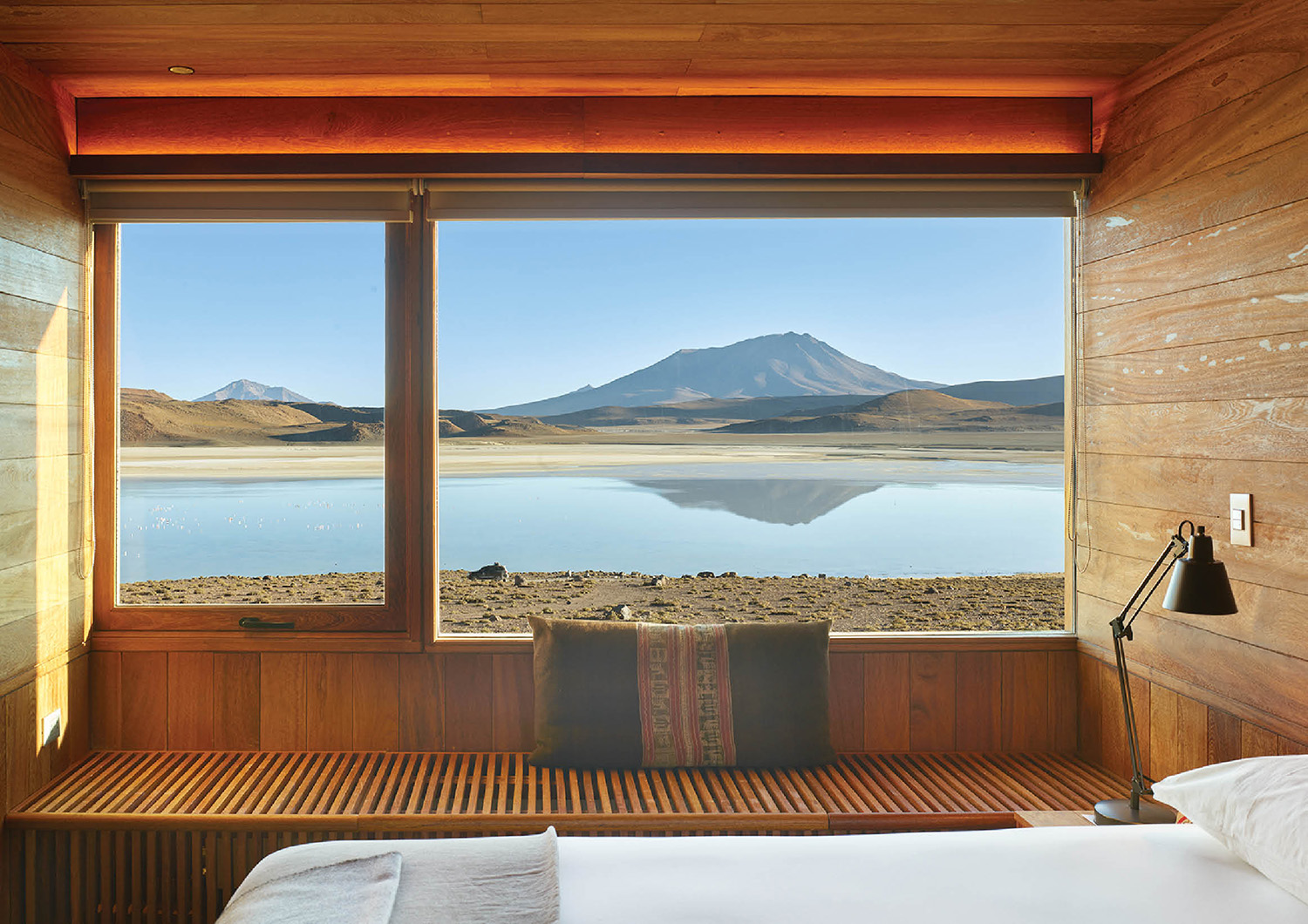 A bed sitting in a room next to a window