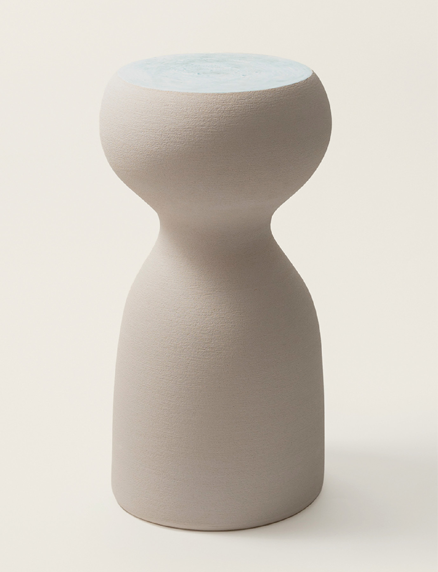 A white vase with a blue top