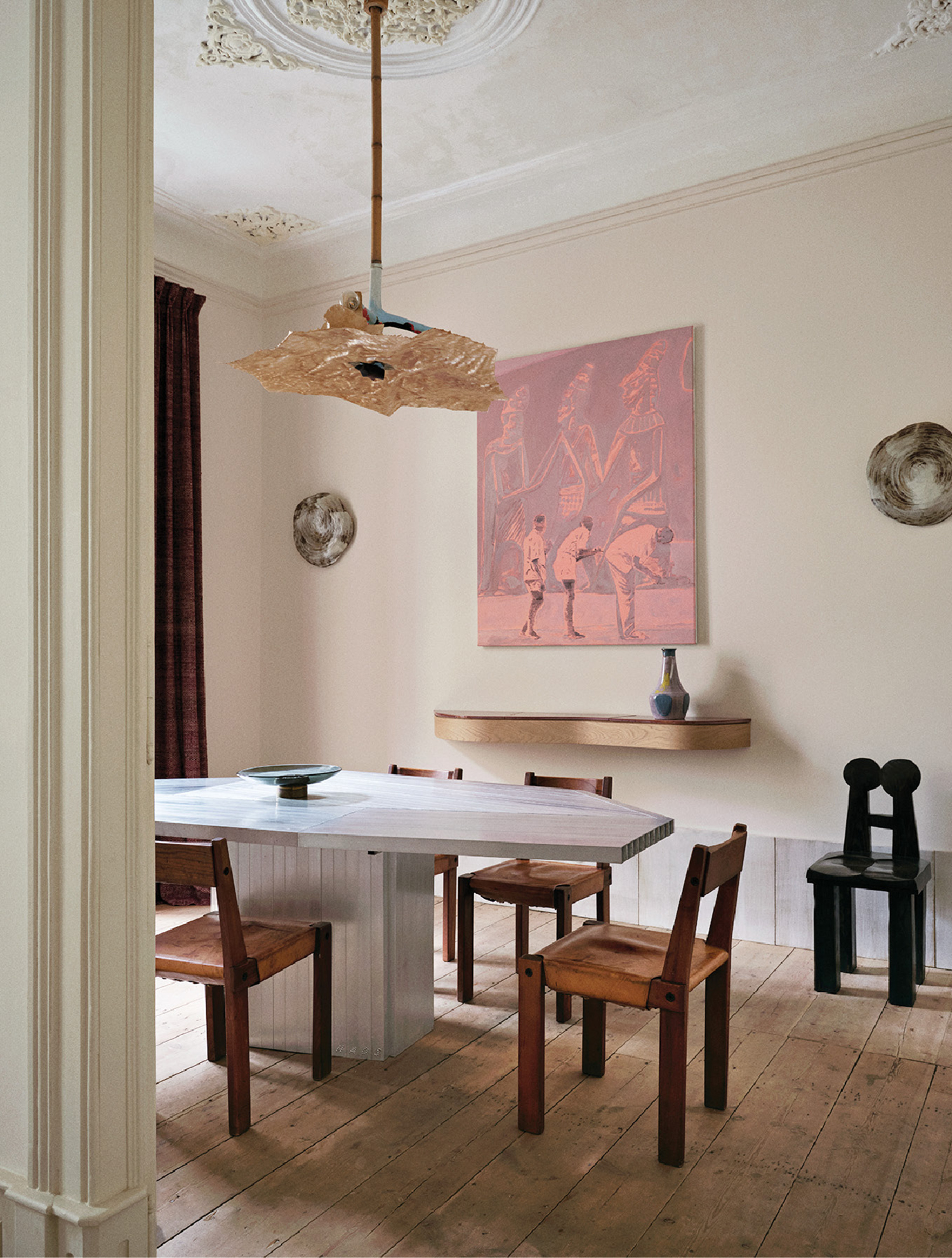 A dining room with a table and chairs