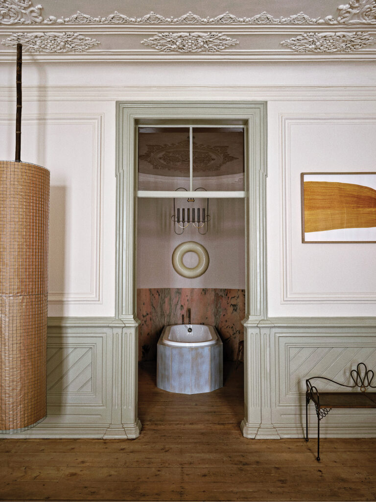 A bathroom with a toilet and a basket