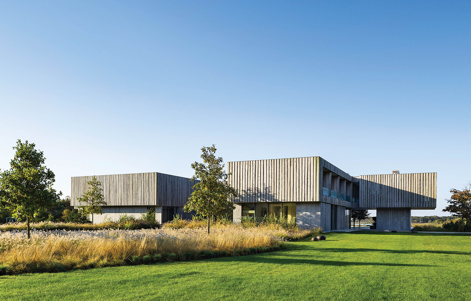 exterior of home surrounding by a grassy field