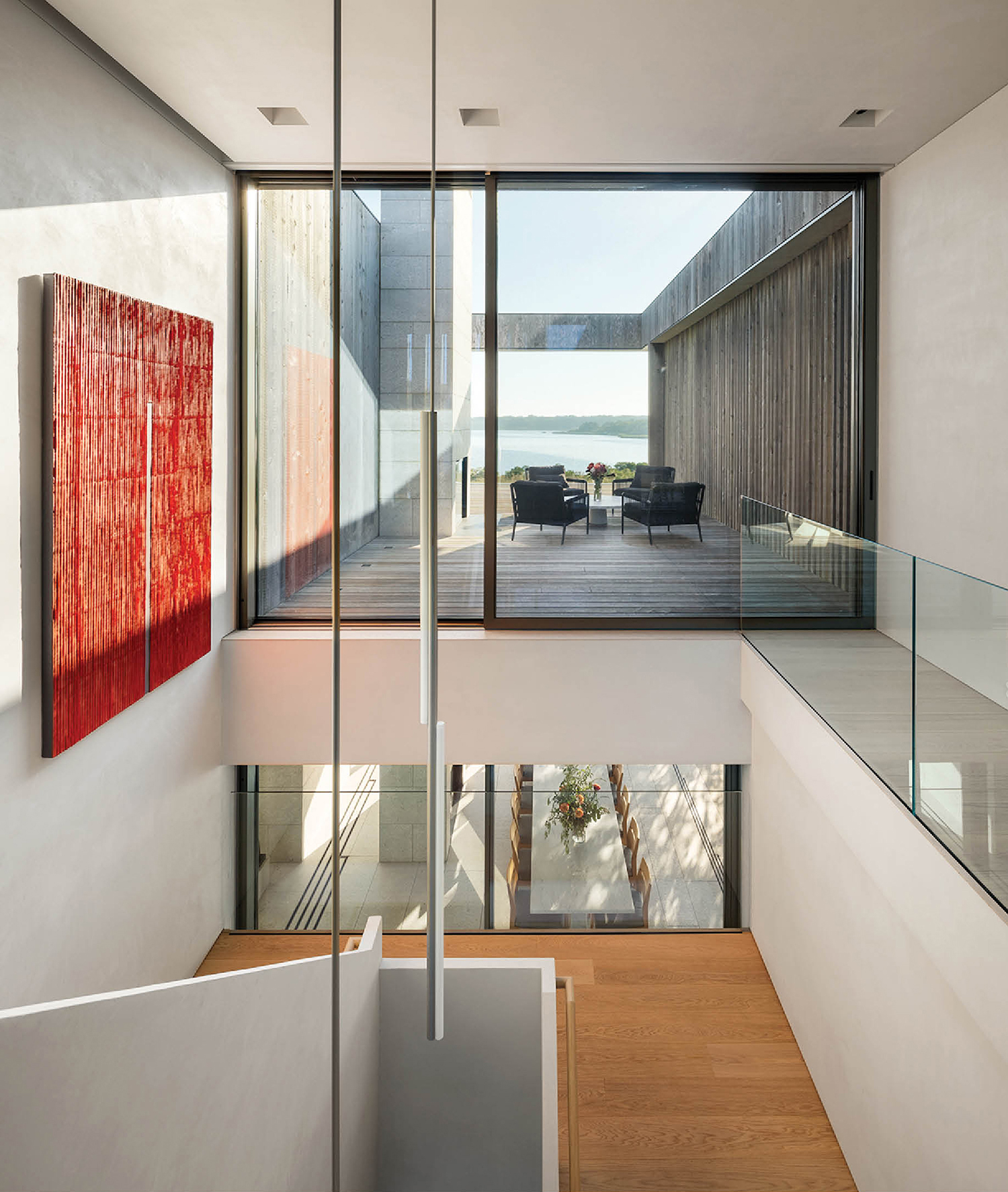 two level stairwell with large window and hanging chandelier