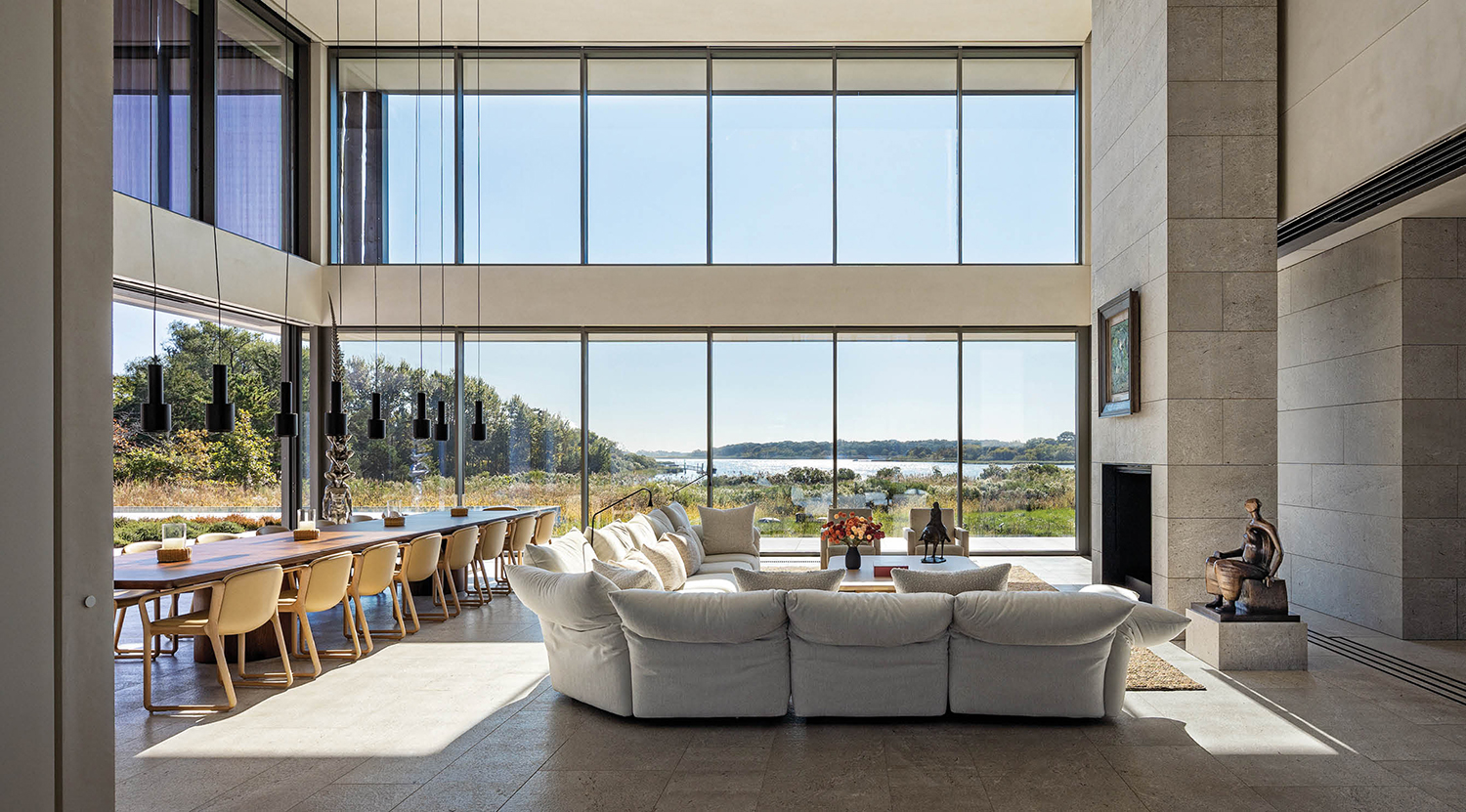 living room with white couch and multiple windows facing the scenery outside