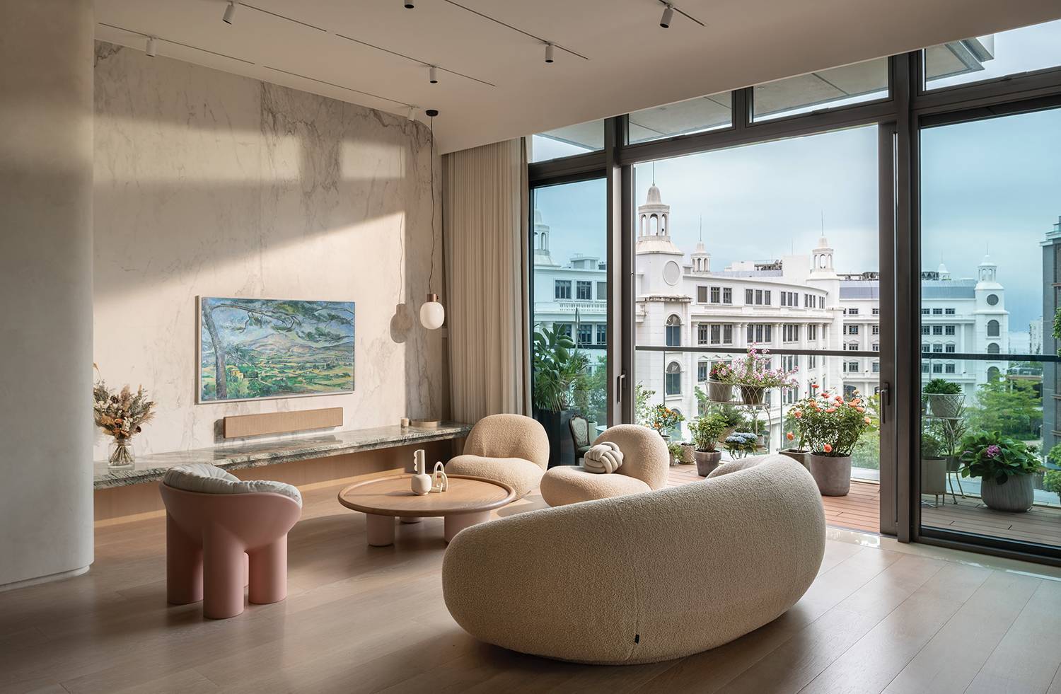 a living room with a large window and a large painting on the wall