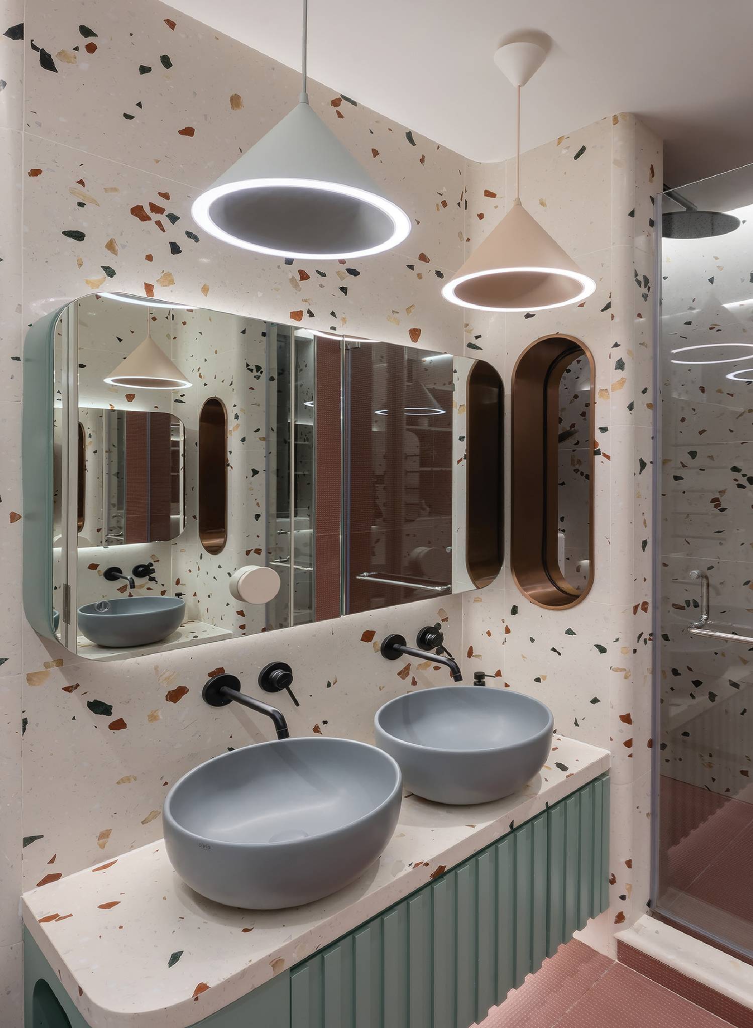 a bathroom with two sinks and mirrors