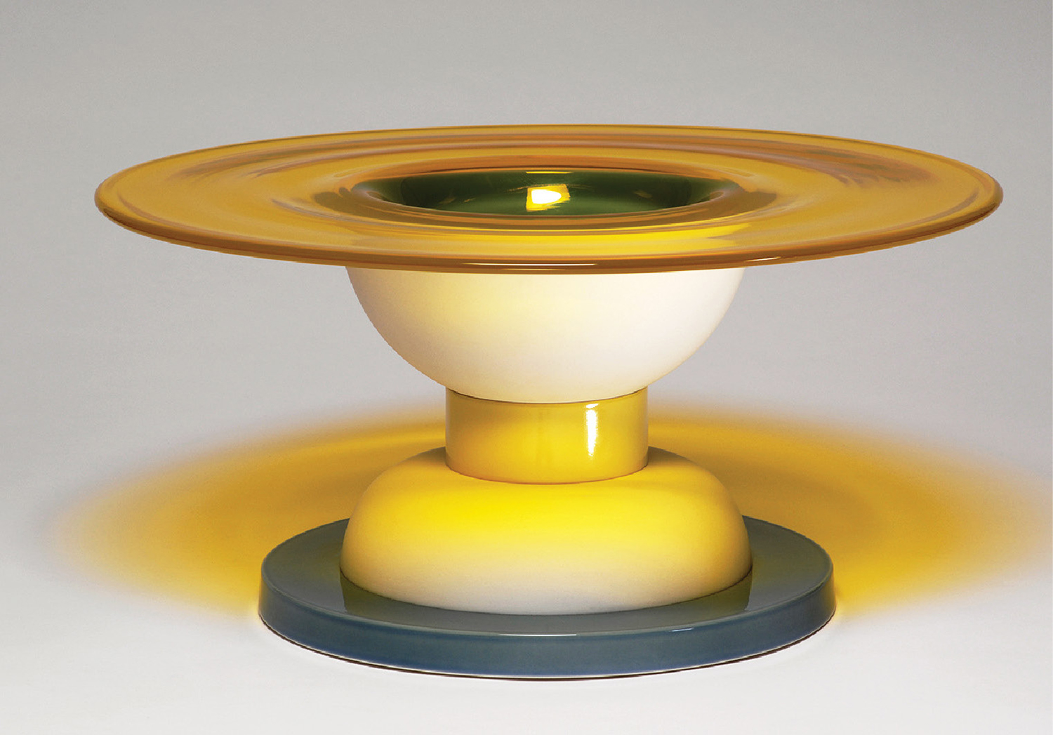 A yellow and blue candle holder