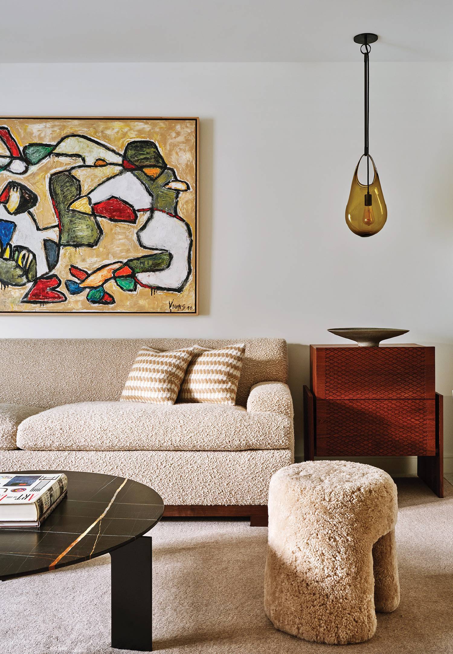 A living room with a couch, chair and ottoman