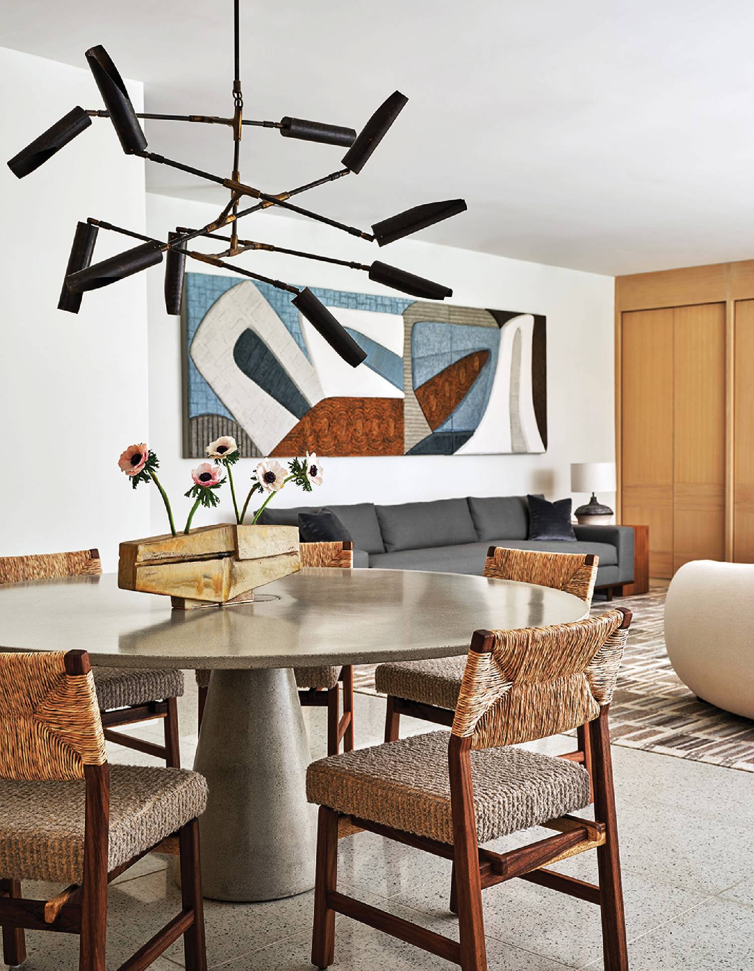 A dining room with a round table and chairs