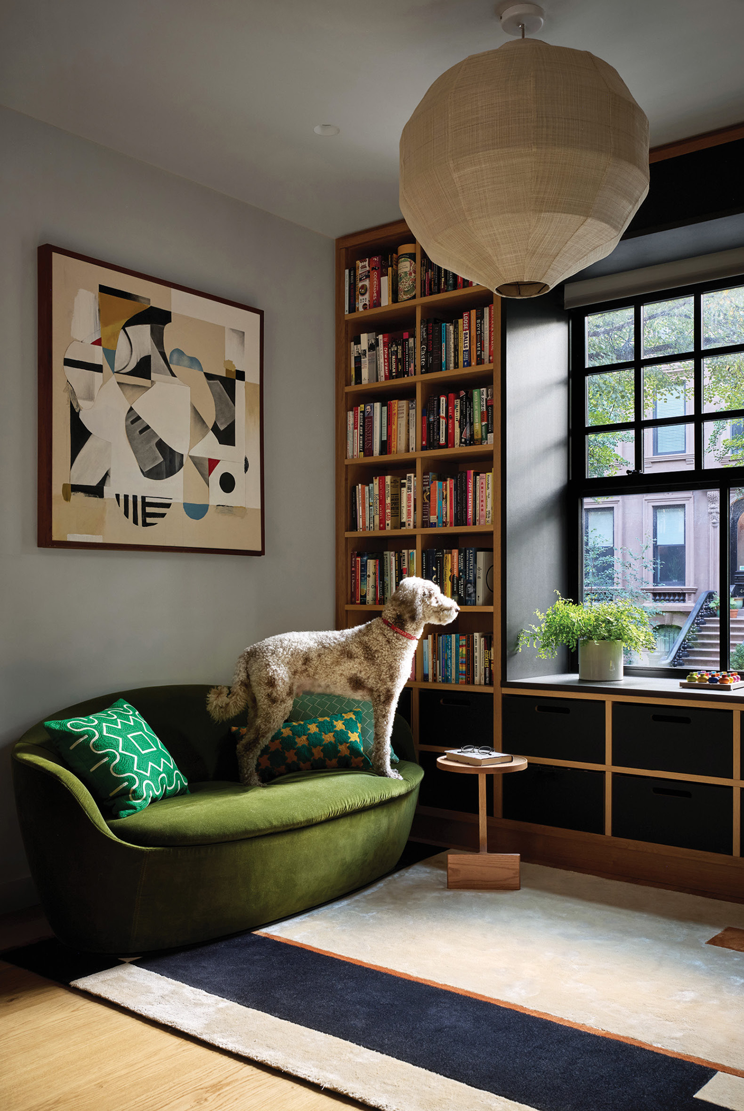 A dog sitting in a green chair in a living room