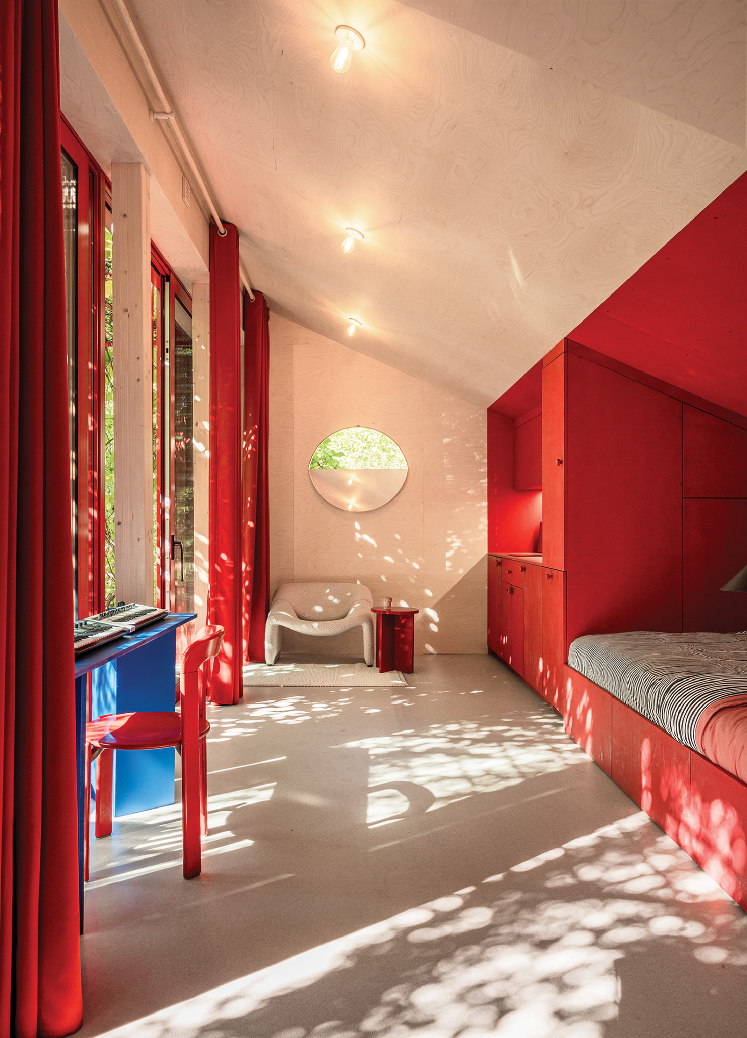A bedroom with a bed and a desk