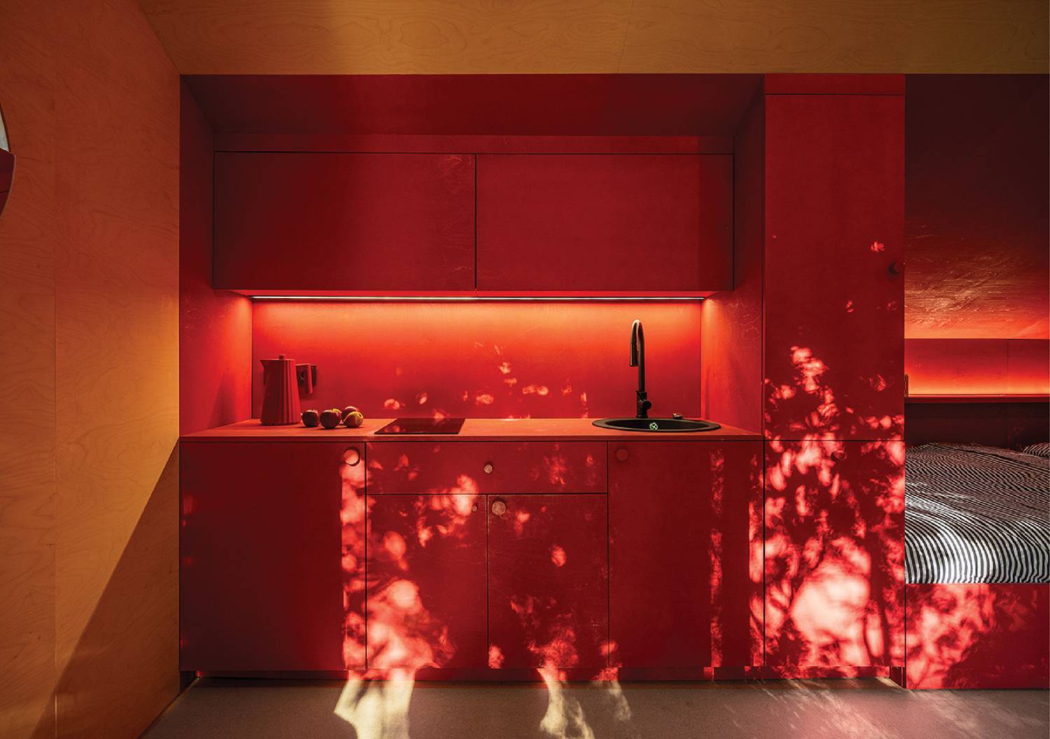 a red kitchen with a sink and a sink