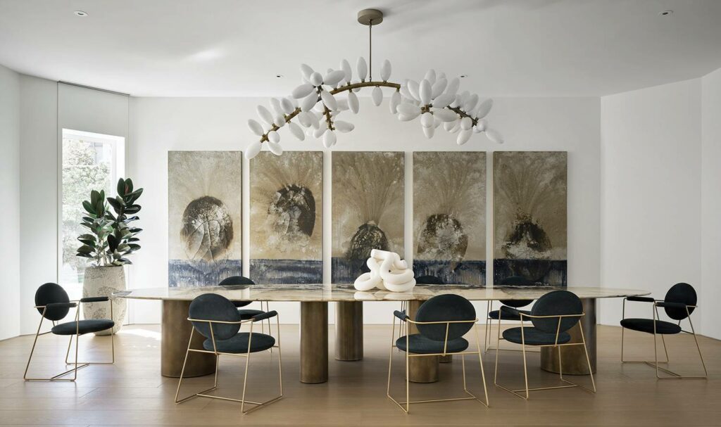 a dining room with a large painting on the wall