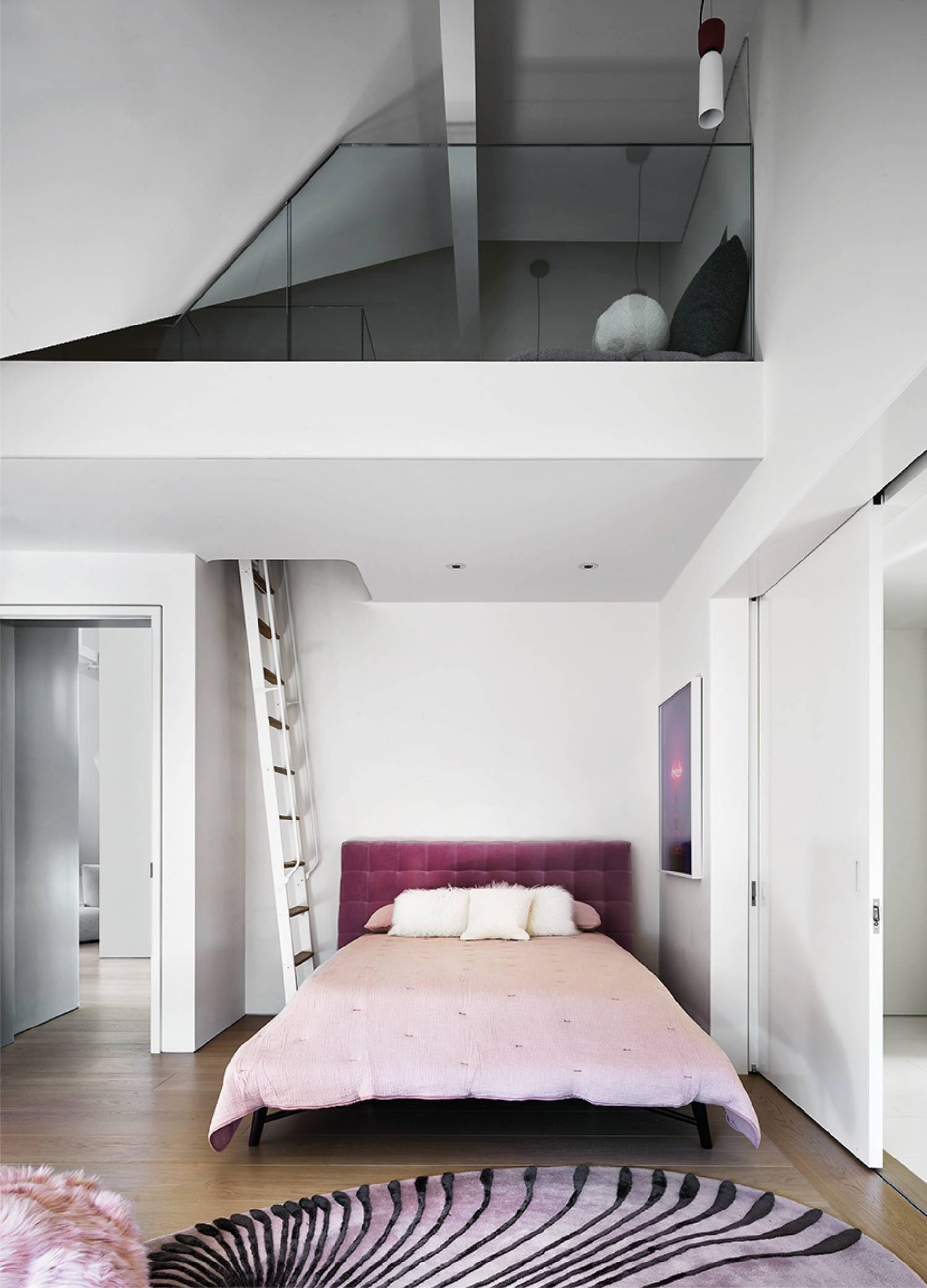a bedroom with a bed and a staircase