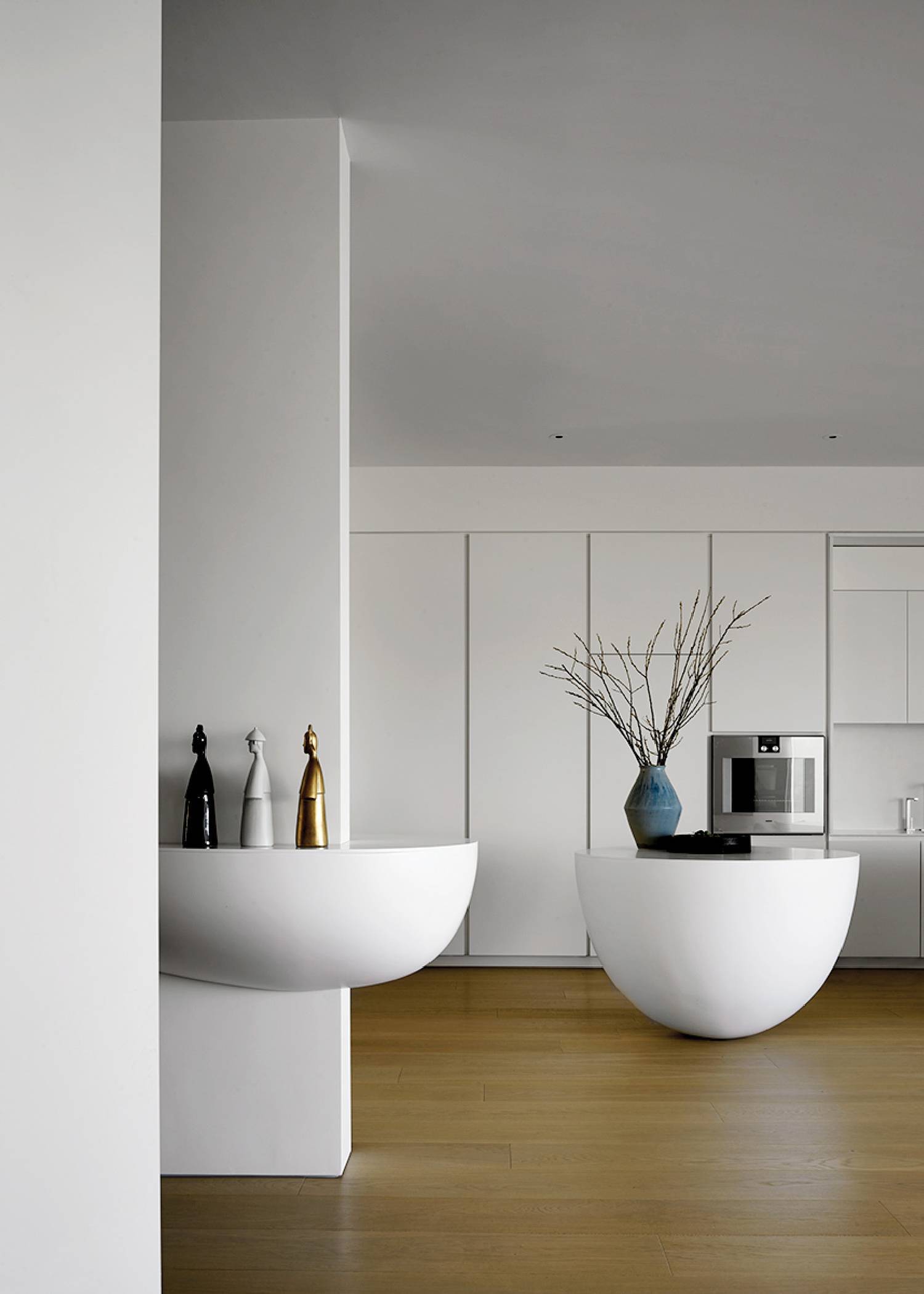 a white kitchen with two large white bowls
