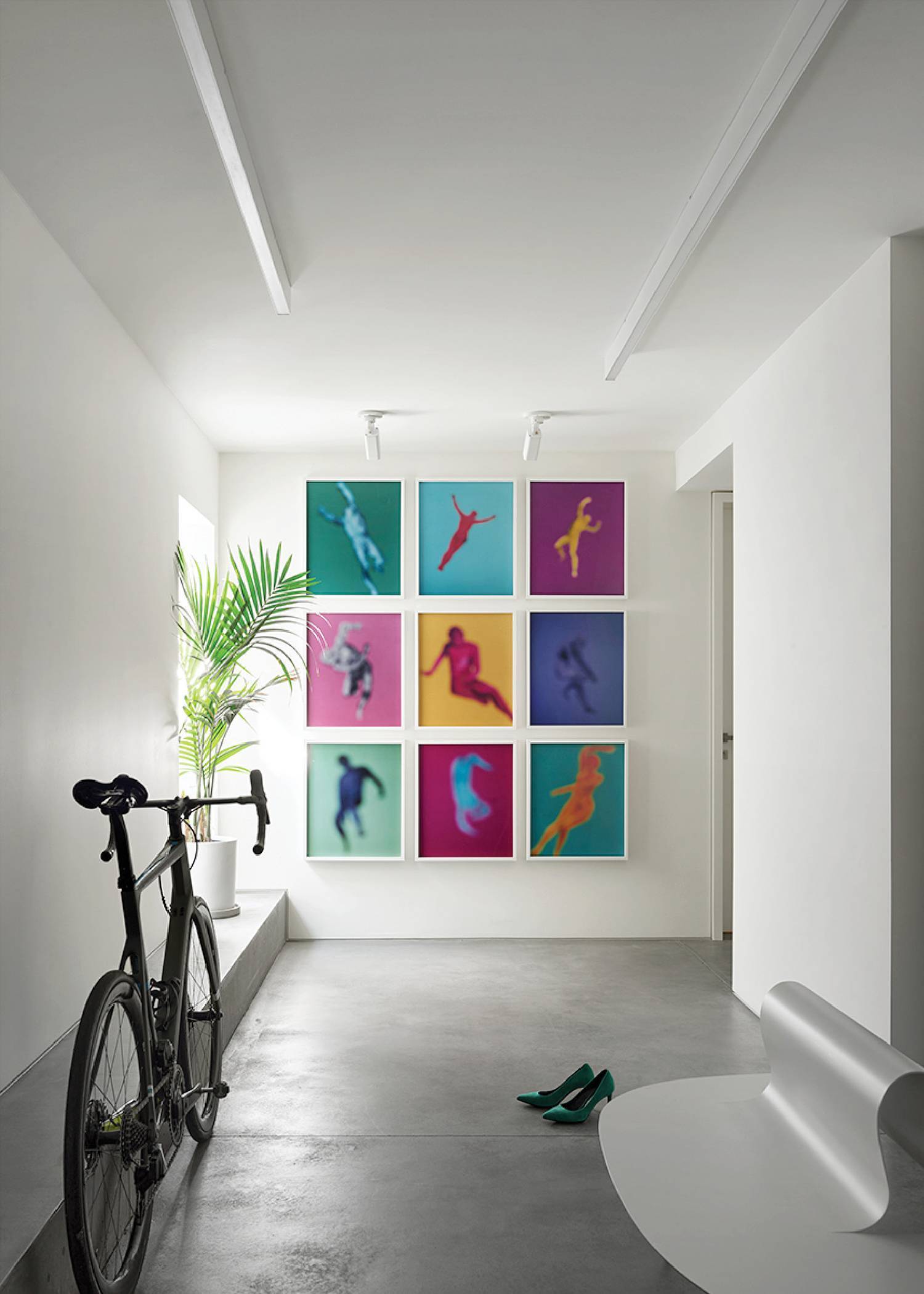 a bike parked in front of a wall with colorful paintings