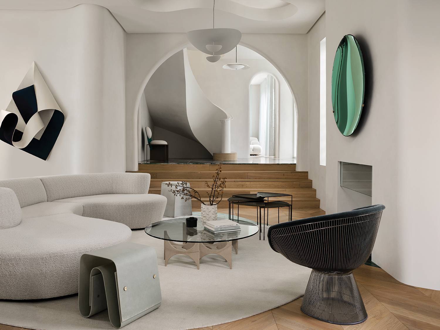 a living room with a round couch and a round table in home by Greg Natale