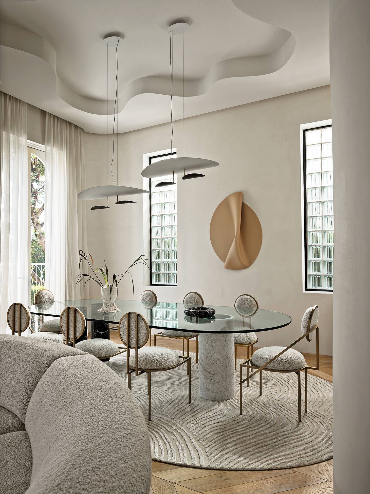 a living room with a round table and chairs in home by Greg Natale