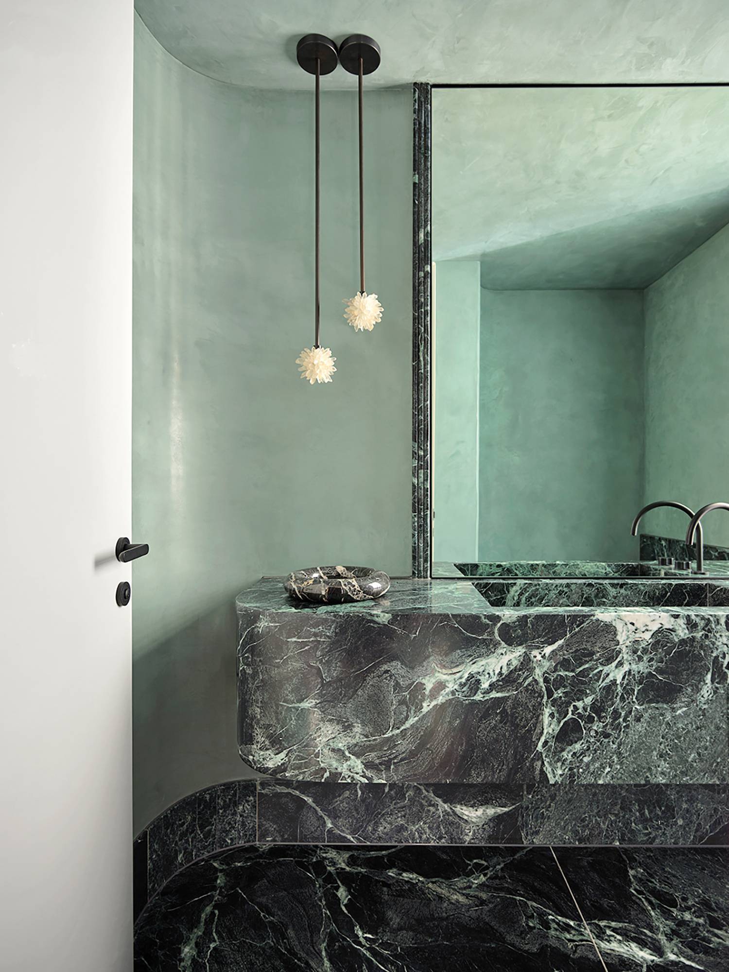 a bathroom with a marble counter and a mirror