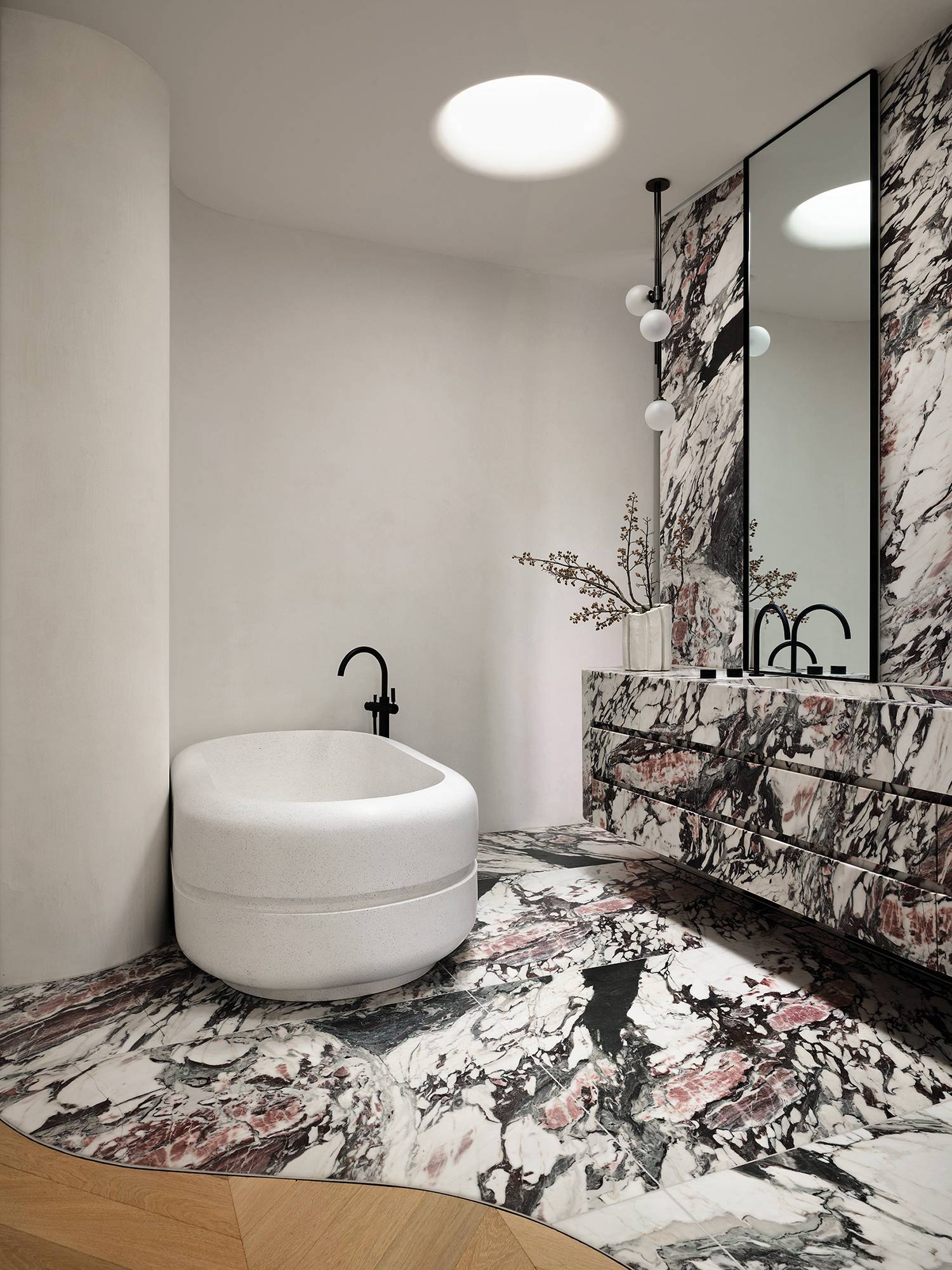 a bathroom with a large white tub and a black and white marbles