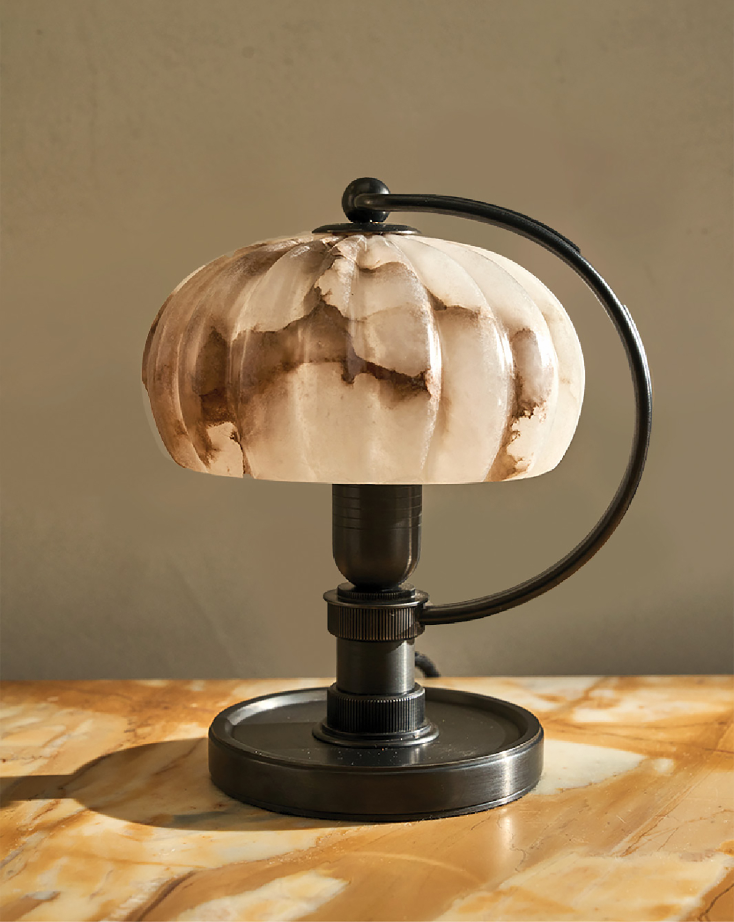 A table lamp with a marble shade