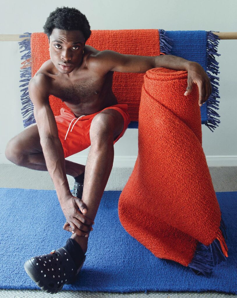 a man sitting on a blue rug