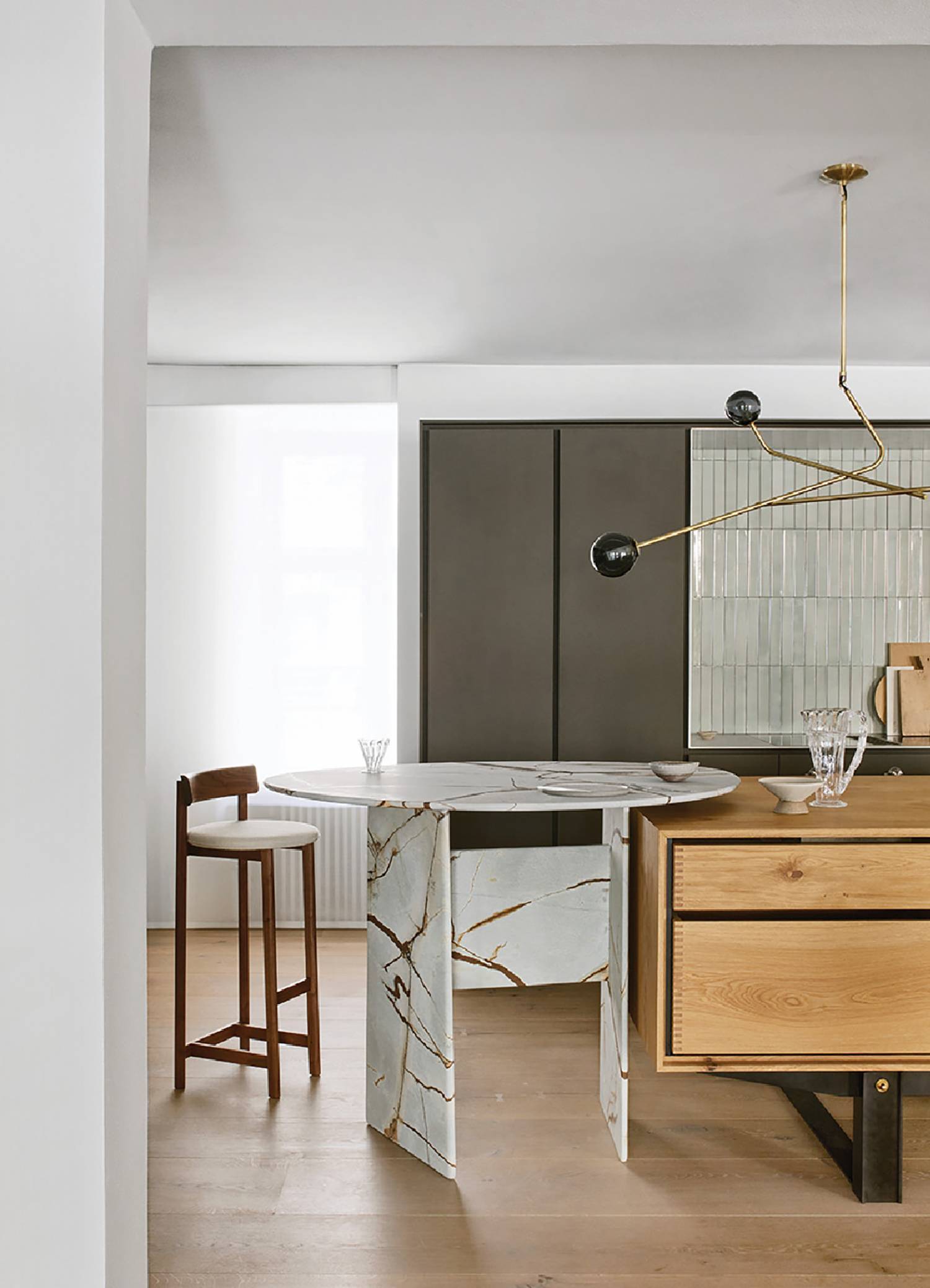 a kitchen with a marble island and wooden cabinets