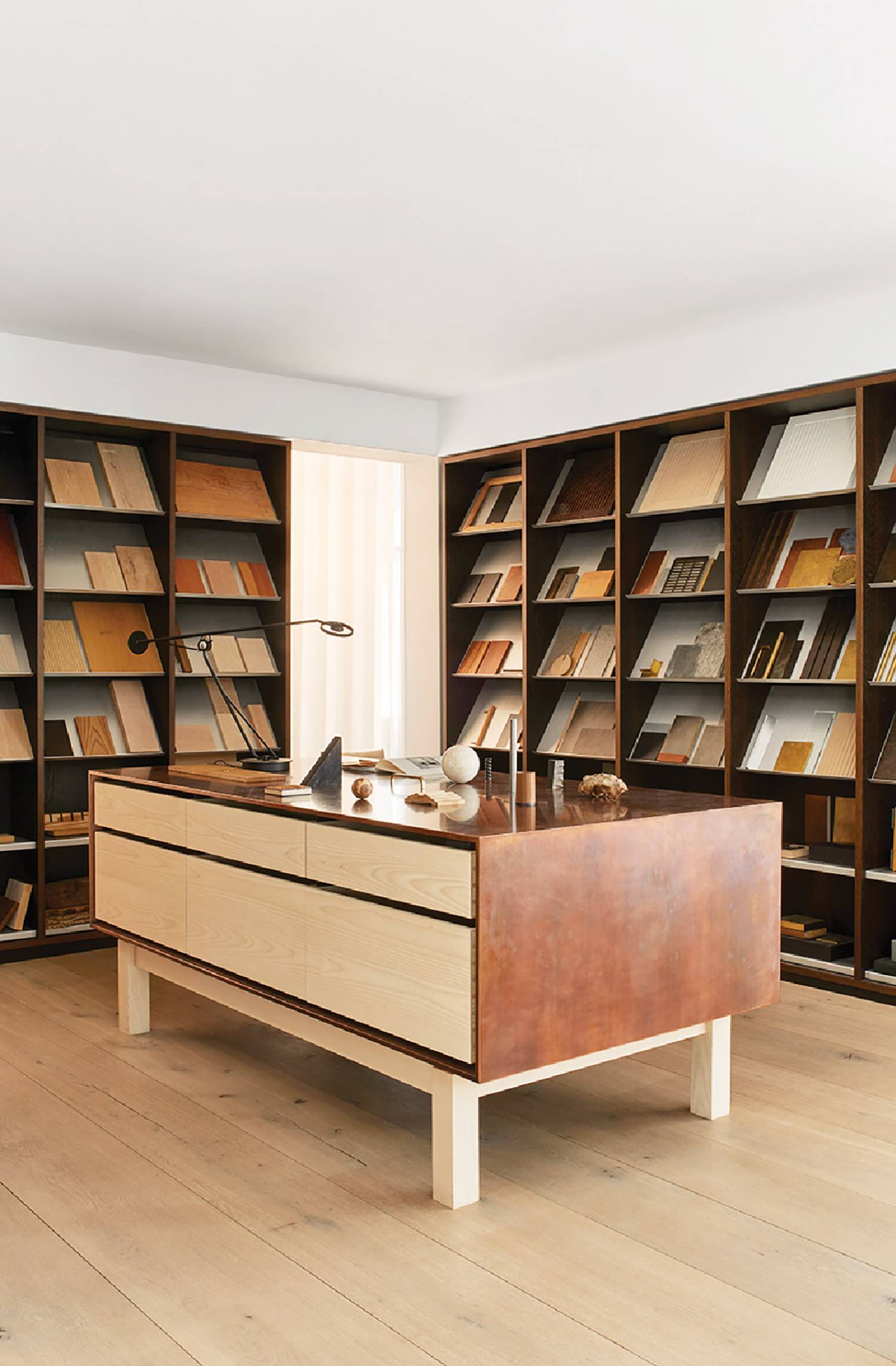 a wooden desk with a bookcase and bookshel