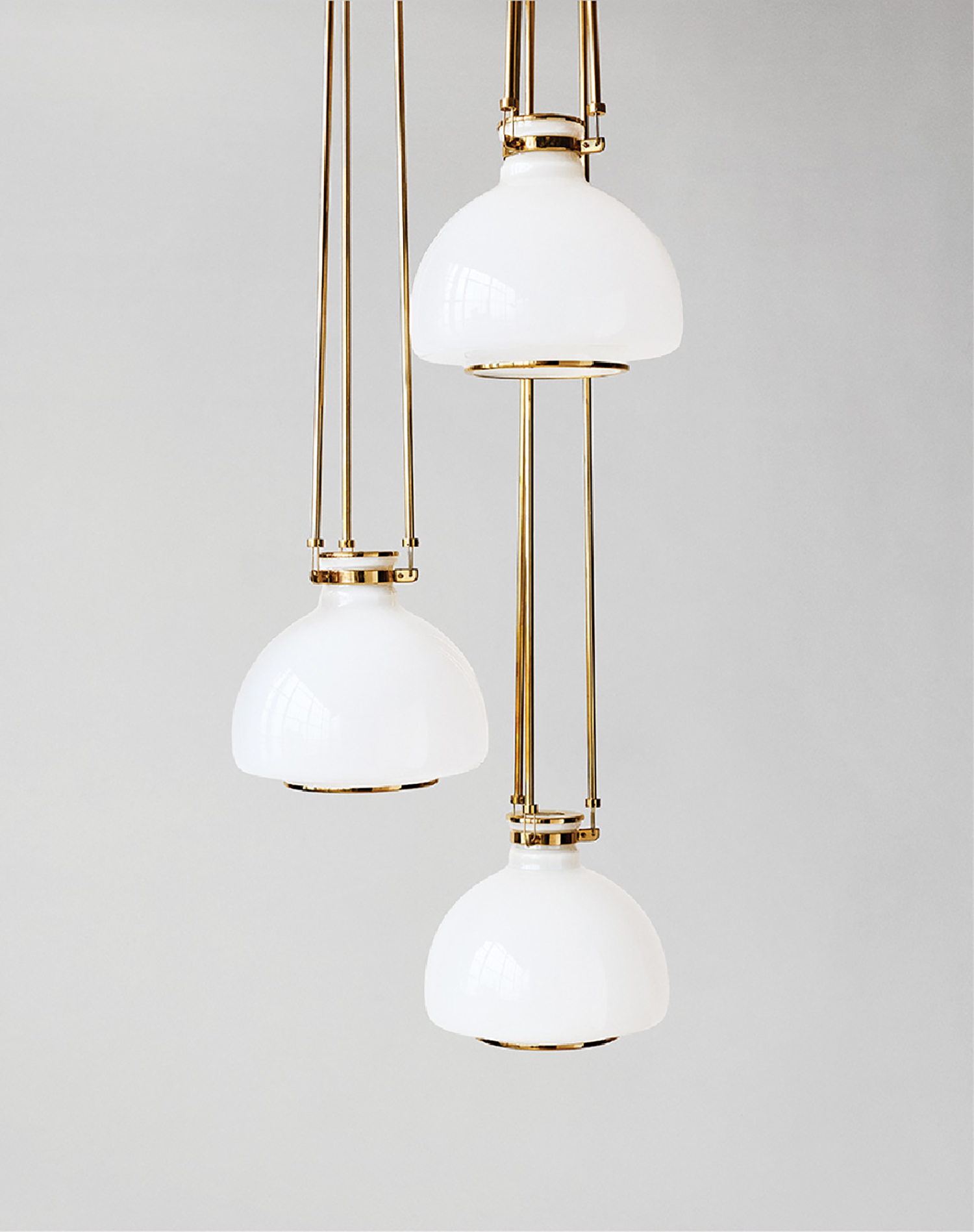 Three white glass lamps hanging from the ceiling