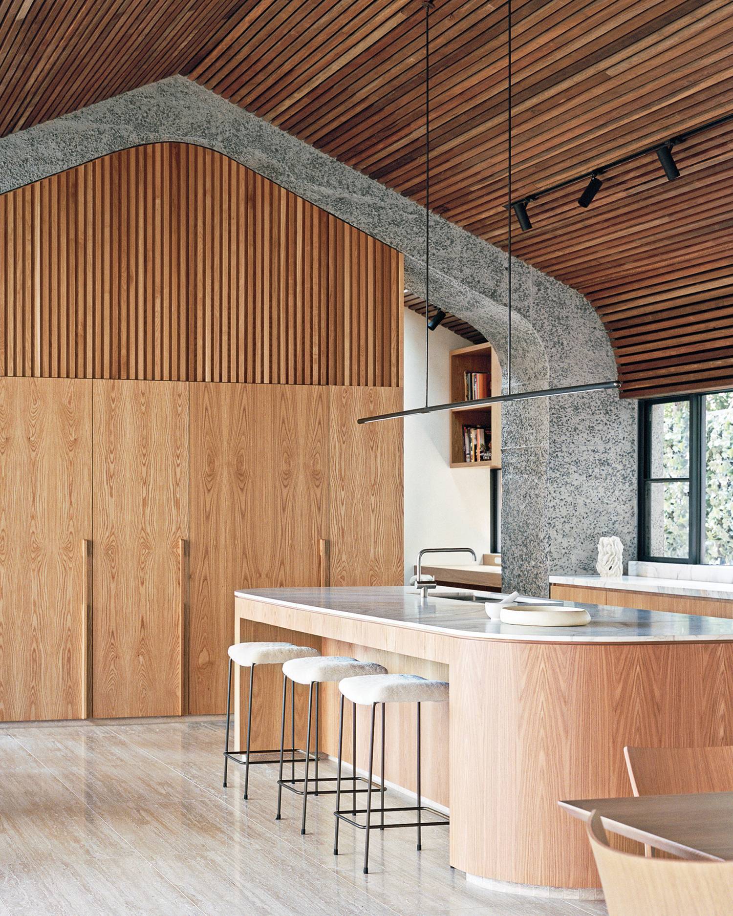 a kitchen with wooden walls and a large island