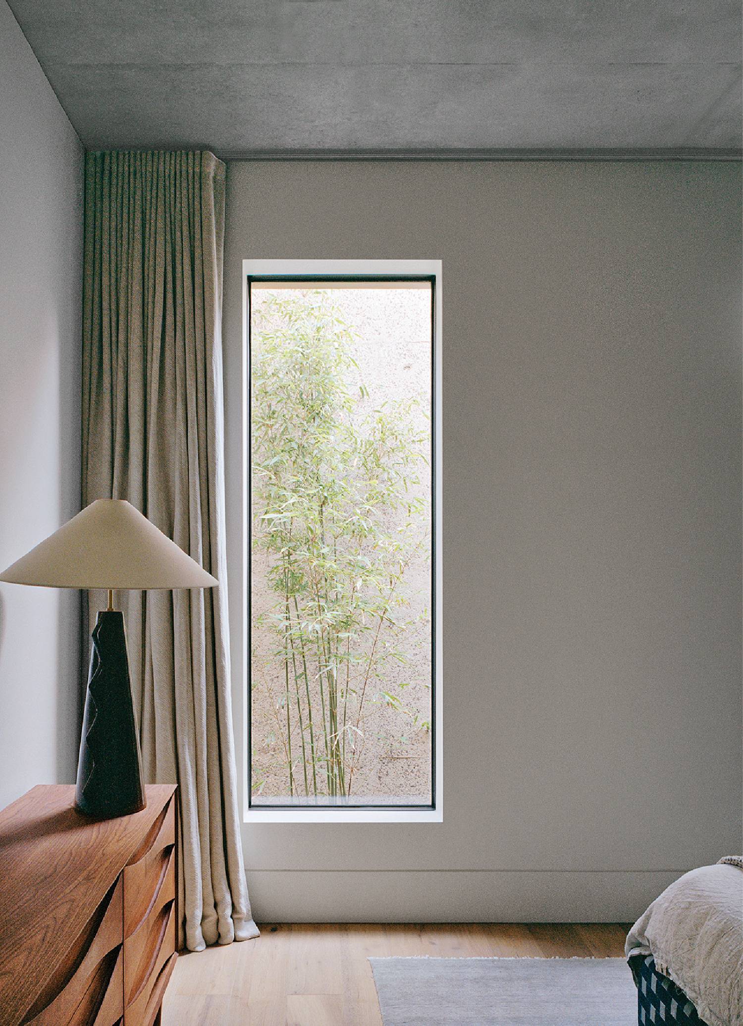 A bedroom with a bed and a window