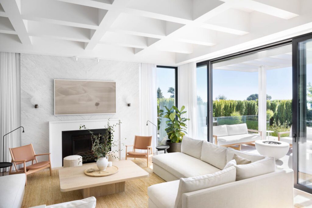 In the living room, Andrea Rodmann Interiors designed the custom L shaped sofas and the coffee table, which was made by Lock and Mortice. The Summit lounge chairs designed by Norm Architects for Ariake are from Hem Interiors.