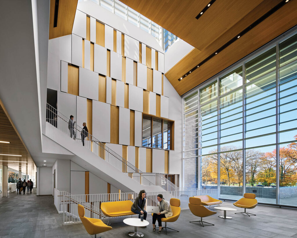 a seating area with yellow furnishings in The Graham Athletics & Wellness Center