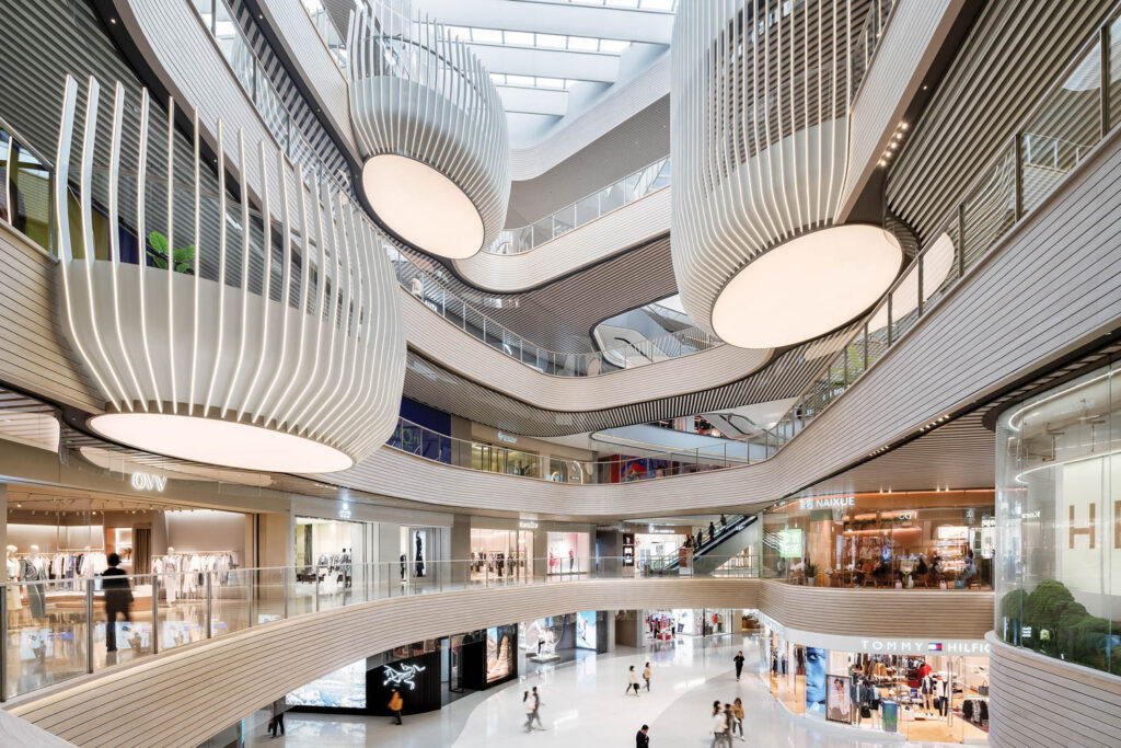 a shopping mall with winding white railings on each level