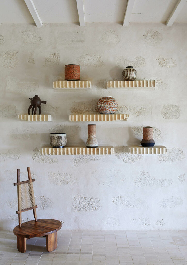 A walnut Wilson chair by Eloi Schultz and Jose Carvalho ceramics on the upstairs landing.