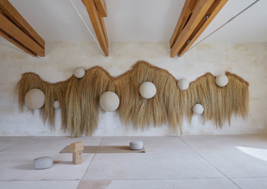 a yoga studio with wood beam ceilings and a wall installation