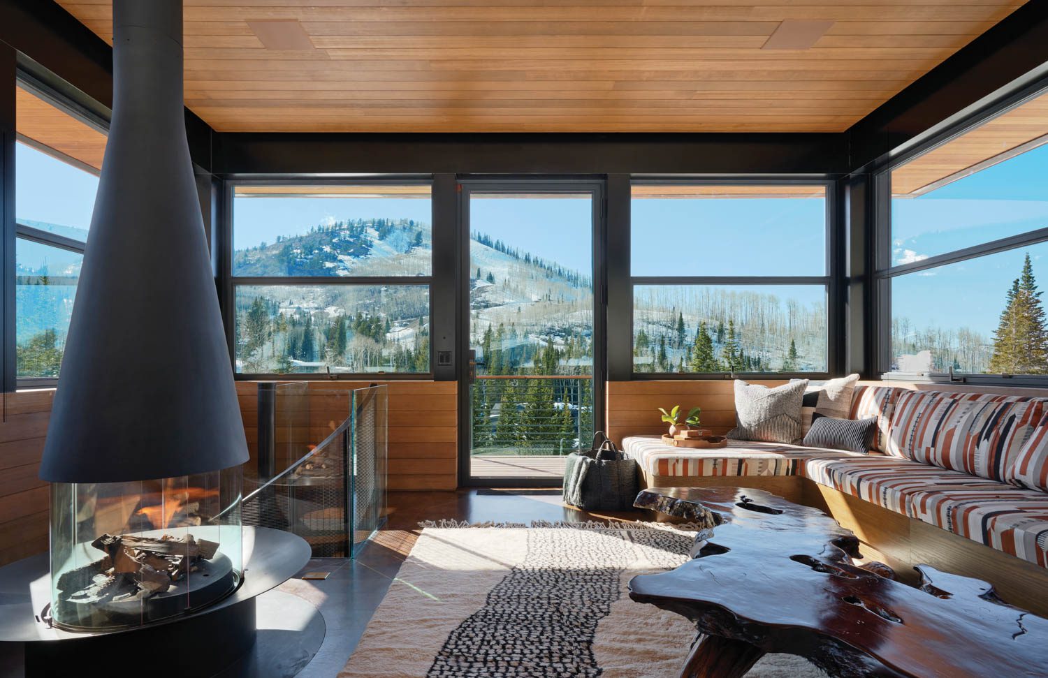 tower room of a ski chalet with wraparound porch, seating and mountain views