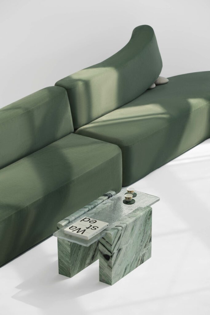 a green sofa and rippled glass green coffee table