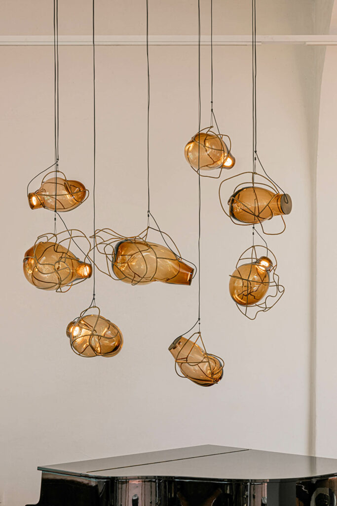 molten glass light fixtures hang from above